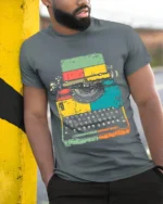 Retro Colorful Typewriter Graphic Printed T-Shirt - model in grey shirt leaning against column