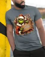 Funny Grinch Merry Christmas Holiday T-Shirt - model in grey shirt leaning against column