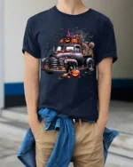 Halloween Pumpkin Witch Vintage Truck T-Shirt - model wearing navy shirt, hands in pockets