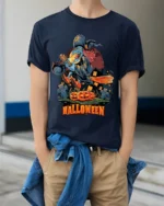 Flying Witch Broomstick Pumpkin Halloween Graphic T-Shirt - model wearing navy shirt, hands in pockets