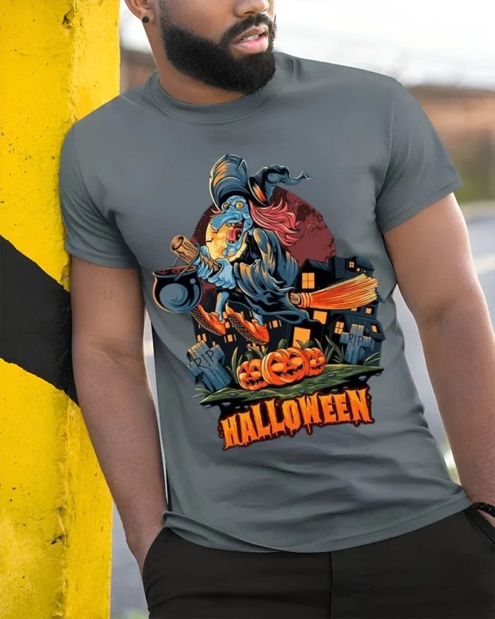 Flying Witch Broomstick Pumpkin Halloween Graphic T-Shirt - model in grey shirt leaning against column