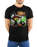 Halloween Green Witch Cauldron Potion Graphic T-Shirt - model wearing black shirt, hands behind back