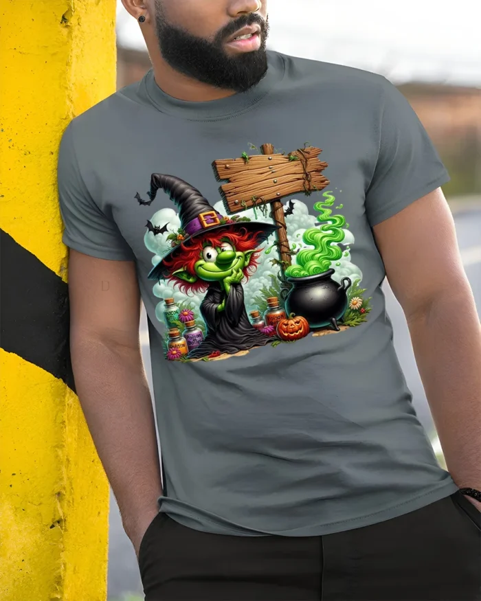 Halloween Green Witch Cauldron Potion Graphic T-Shirt - model in grey shirt leaning against column