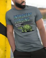 Introvert Loading Funny Turtle Graphic T Shirt - model wearing grey tee, leaning on column