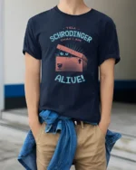 Funny Tell Schrodinger That I Am Alive Cat Science Humor T Shirt - model wearing navy tee with hands in pockets