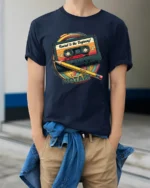 Retro Rewind To The Beginning Cassette Tape Graphic T Shirt - model wearing navy tee with hands in pockets