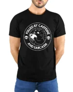 Fueled By Caffeine And Sarcasm Funny Cat Coffee Humor T Shirt - model wearing black tee with hands behind back