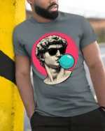 Cool David Statue Bubblegum Pop Art Graphic T Shirt Retro Aesthetic - model wearing grey tee, leaning on column