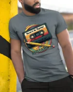 Retro Rewind To The Beginning Cassette Tape Graphic T Shirt - model wearing grey tee, leaning on column