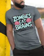 Zombies Eat Brains Funny Zombie Humor Graphic T Shirt - model wearing grey tee, leaning on column