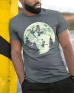 Funny Moonlight BMX Alien Parody Graphic T Shirt Retro Bike Tee - model wearing grey tee, leaning on column