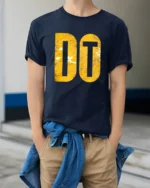 Just Do It Inspired Motivational Bold Typography Graphic T Shirt - model wearing navy tee with hands in pockets