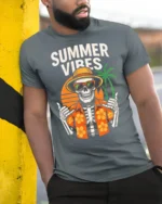 Summer Vibes Skeleton T Shirt Funny Tropical Skull Beach Graphic - model wearing grey tee, leaning on column
