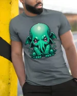 Cute Cthulhu Monster T Shirt Adorable Lovecraft Inspired Cartoon Graphic - model wearing grey tee, leaning on column