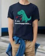 Funny T Rex I Am Unstoppable Tiny Arms Dinosaur Graphic T Shirt - model wearing navy tee with hands in pockets