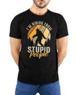 Funny Bigfoot Im Hiding From Stupid People Vintage T Shirt - model wearing black tee with hands behind back
