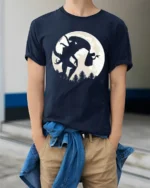 Creepy Mothman Cryptid Legend Moon Silhouette Graphic T Shirt - model wearing navy tee with hands in pockets