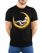 Dreaming Astronaut Resting On Moon Space Art Graphic T Shirt - model wearing black tee with hands behind back
