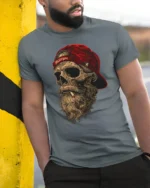 Bearded Skull With Red Cap Rebel Biker Graphic T Shirt - model wearing grey tee, leaning on column
