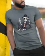 Gangster Skeleton With Cigar Dark Humor Graphic T Shirt - model wearing grey tee, leaning on column