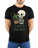 Funny Trying To Stay Alive Skeleton Plant Graphic T Shirt - model wearing black tee with hands behind back