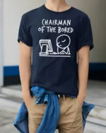 Funny Chairman Of The Bored Office Humor Graphic T Shirt - model wearing navy tee with hands in pockets