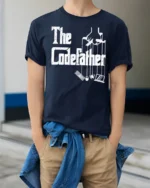 Funny The Codefather Programmer Humor Coding Graphic T Shirt - model wearing navy tee with hands in pockets