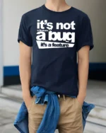 Funny Its Not A Bug Its A Feature Programmer Humor T Shirt - model wearing navy tee with hands in pockets