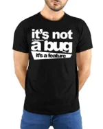 Funny Its Not A Bug Its A Feature Programmer Humor T Shirt - model wearing black tee with hands behind back