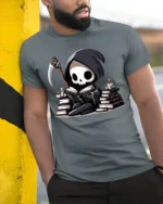 Cute Grim Reaper Reading Books Funny Dark Humor T Shirt - model wearing grey tee, leaning on column