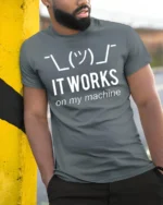 Funny It Works On My Machine Programmer Humor T Shirt - model wearing grey tee, leaning on column