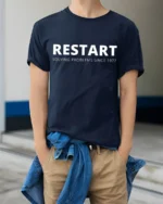 Restart Solving Problems Since 1977 Funny Tech Humor T Shirt - model wearing navy tee with hands in pockets