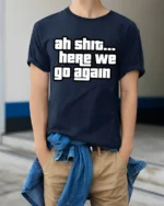 Ah Shit Here We Go Again Funny Meme Quote Graphic T Shirt - model wearing navy tee with hands in pockets