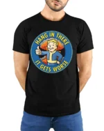 Hang In There It Gets Worse Funny Fallout Style Meme Graphic T Shirt - model wearing black tee with hands behind back