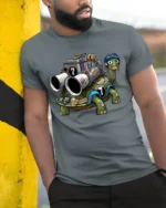 Funny Racing Turtle With Engine Cartoon Graphic T Shirt - model wearing grey tee, leaning on column