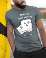 Funny Toilet Paper Assholes Everywhere Meme T Shirt - model wearing grey tee, leaning on column