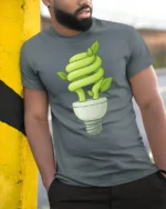 Eco Light Bulb Plant Growth Green Energy Graphic T Shirt - model wearing grey tee, leaning on column