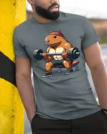 Strong Capybara Gym Lover Funny Fitness Graphic T Shirt - model wearing grey tee, leaning on column