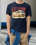 Lets Cook RV Camper Graphic T Shirt Funny Vintage Road Trip Style - model wearing navy tee with hands in pockets