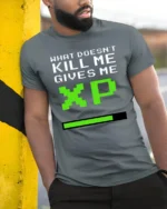 What Doesnt Kill Me Gives Me XP Funny Gamer Graphic T Shirt Retro Style - model wearing grey tee, leaning on column