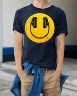 Smiley Face Headphones Graphic T Shirt Retro Music Vibe Tee - model wearing navy tee with hands in pockets