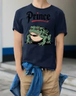 Funny Prince Frog Graphic T Shirt Cute Cartoon Frog Animal Tee - model wearing navy tee with hands in pockets