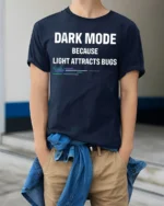 Dark Mode Because Light Attracts Bugs Funny Coding T Shirt Geek Tee - model wearing navy tee with hands in pockets