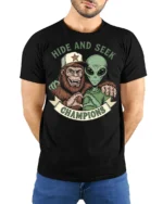 Hide And Seek Champions Funny Alien Bigfoot Graphic T Shirt Style - model wearing black tee with hands behind back