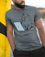 Funny Cat Working On Laptop Graphic T Shirt Cute Tech Kitty Tee - model wearing grey tee, leaning on column