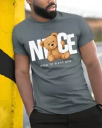 Nice To Meet You Cute Teddy Bear Graphic T Shirt Funny Friendly Tee - model wearing grey tee, leaning on column