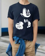 Retro Cartoon Gloves and Face Minimal Graphic T Shirt - model wearing navy tee with hands in pockets