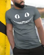 Creepy Cat Smile Halloween Spooky Graphic T Shirt - model wearing grey tee, leaning on column