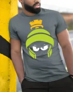 Martian Alien Cartoon Angry Face Funny Graphic T Shirt - model wearing grey tee, leaning on column