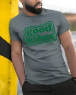 Good Vibes Only Positive Energy Aesthetic Graphic T Shirt - model wearing grey tee, leaning on column